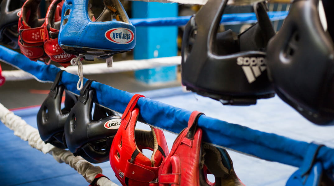 Boxing equipment hanging on ringside ropes