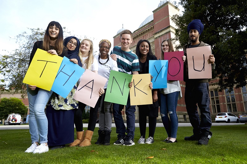 Students holding thank you sign