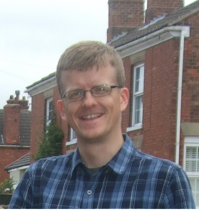 James outside house in blue shirt