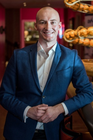 Cameron in blue suit smiling