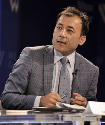 Maiwand Rahyab in a suit holding a pen and notebook