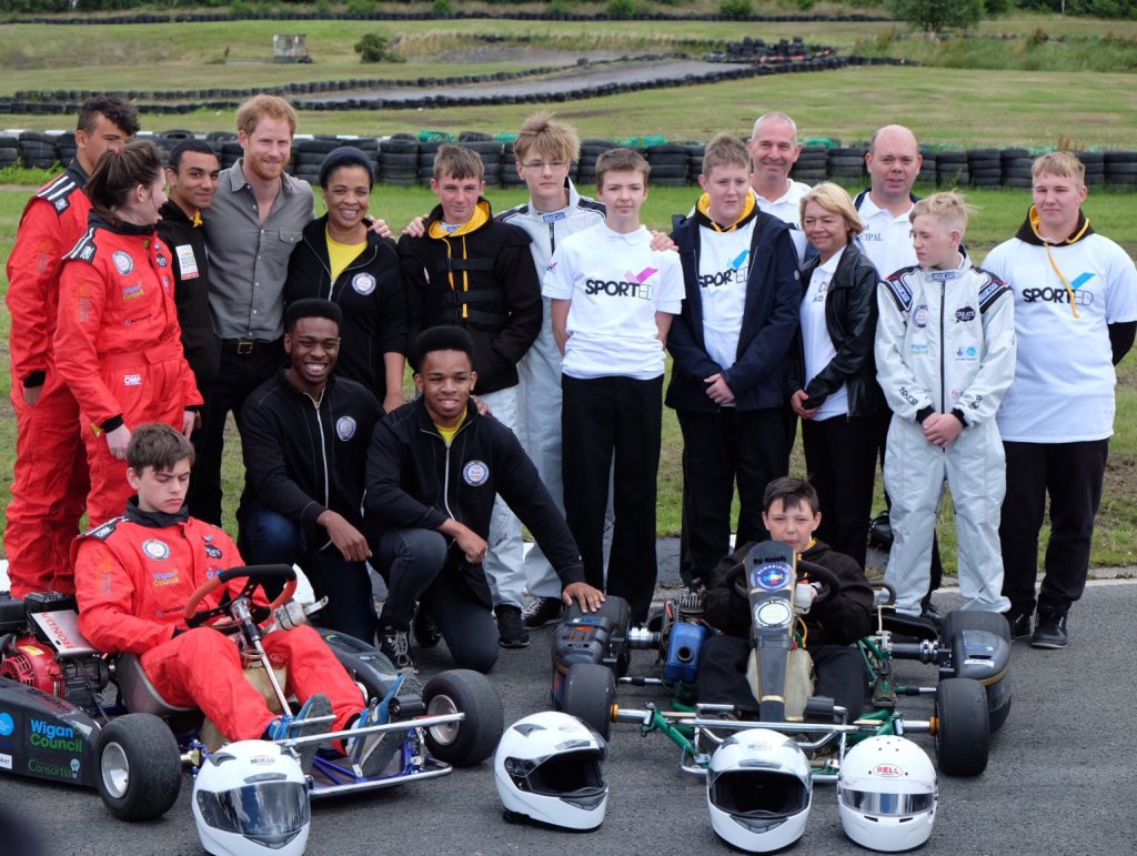 Marilyn (back row, fifth from left) with Prince Harry and her sons Nile and Blair at The Blair Project in Wigan