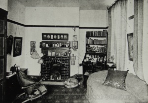 A black and white photo of additional University accomodation in the 1940s, with high ceilings and a brick fireplace