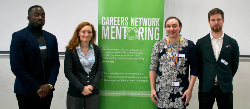 Ademide Adenaike, Kate Stewart, Rose Taylor and James Bunting standing next to sign that says 'Careers Network Mentoring'