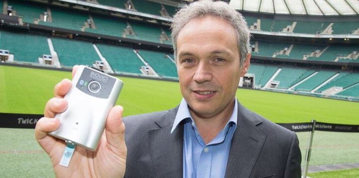 Professor Tony Belli, holding a prototype portable saliva test