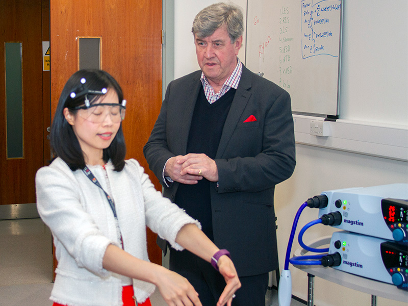 Scientist demonstrates equipment to donor