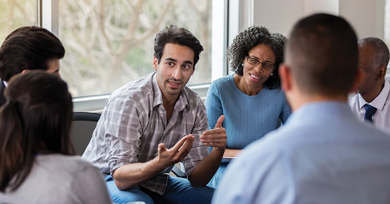 Man talking to therapy group