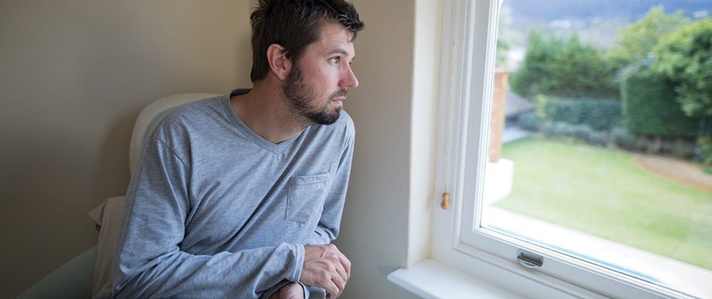 Man looks out of window