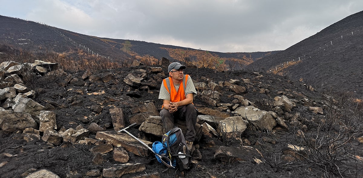 Professor Nick Kettridge surveys a charred landscape