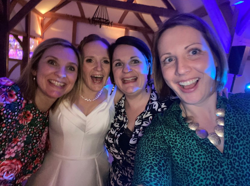 Four friends at a wedding