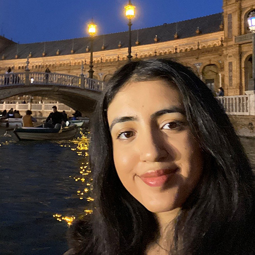 Sarina in front of bridge at night