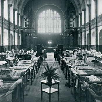 Black and white photo of hospital beds in the Great Hall during wartime
