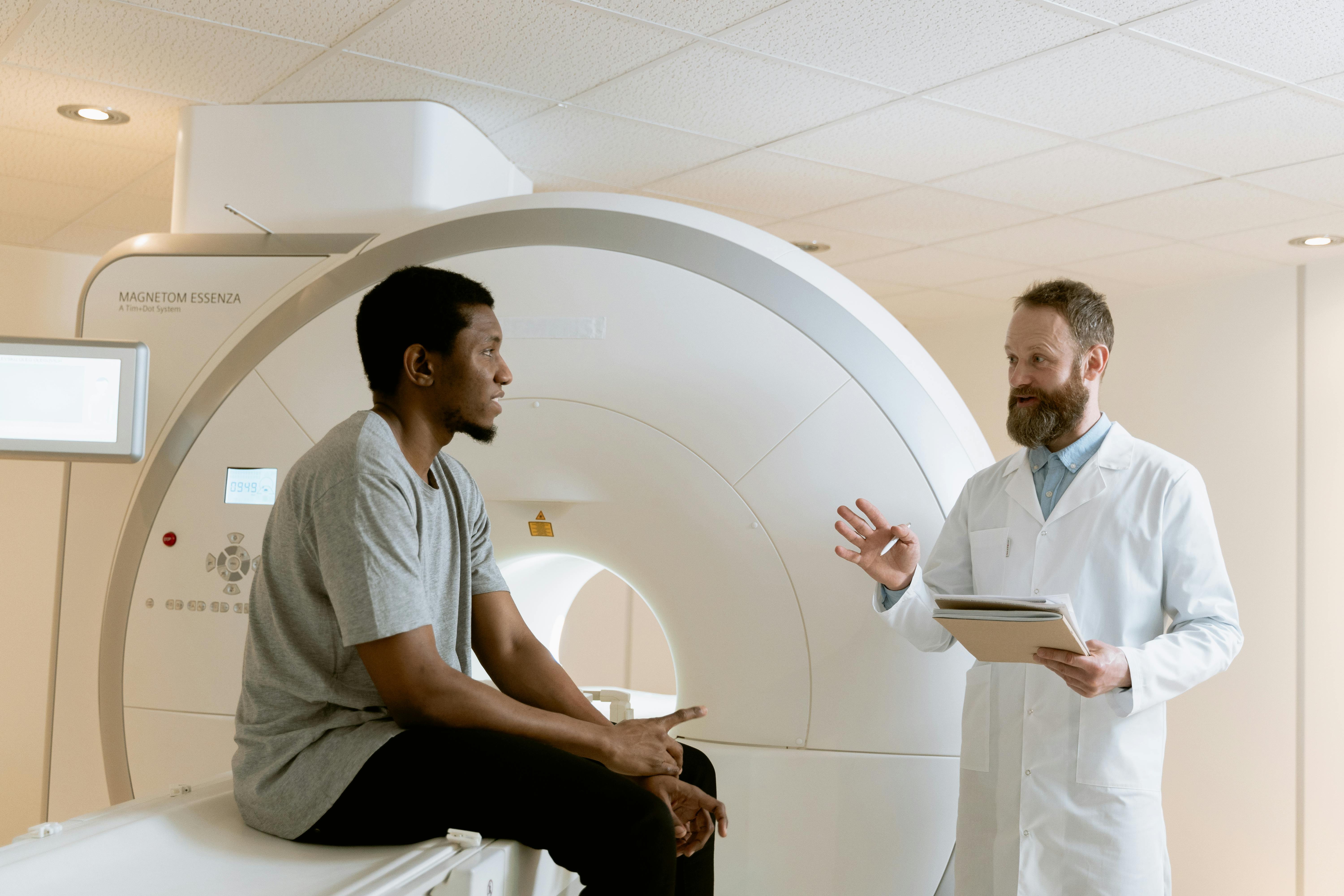 Researcher discusses an MRI scan with patient